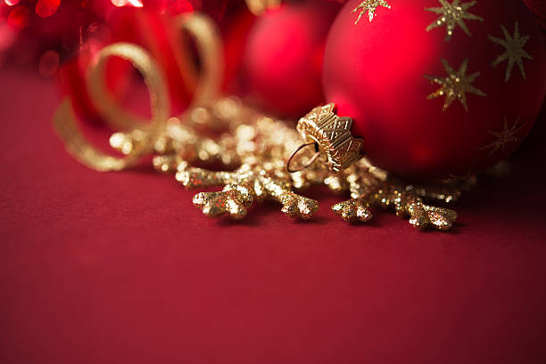 istock Red and golden christmas ornaments on red xmas background 607738574