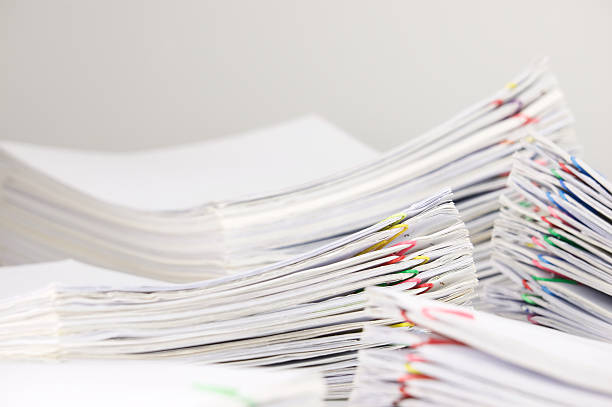 istock Pile overload paperwork have blur pile document foreground and background 607739628