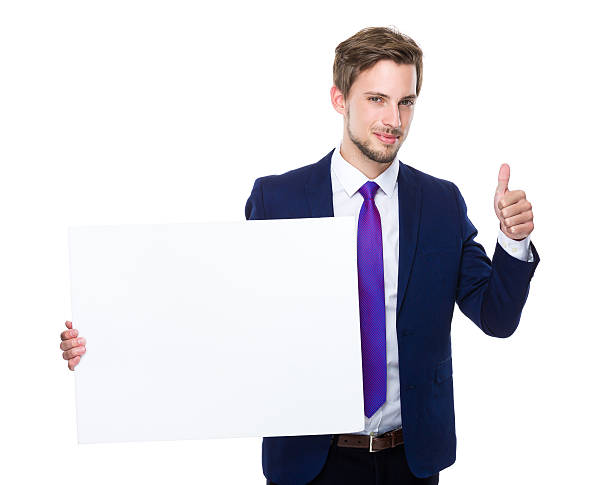 istock Businessman holding blank sign giving thumbs up 607739976