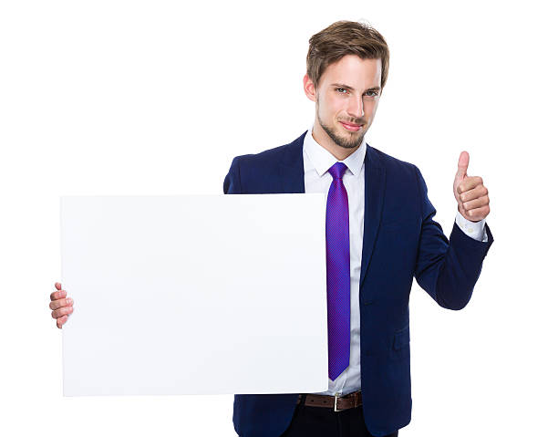 istock Businessman holding blank sign giving thumbs up 607740036