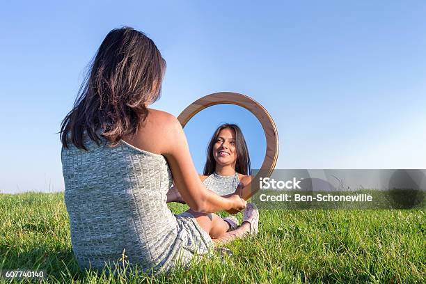 Woman In Nature Viewing Her Mirror Image Stock Photo - Download Image Now - Mirror - Object, Looking, Women