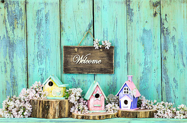 istock Welcome sign hanging over birdhouses 607740208