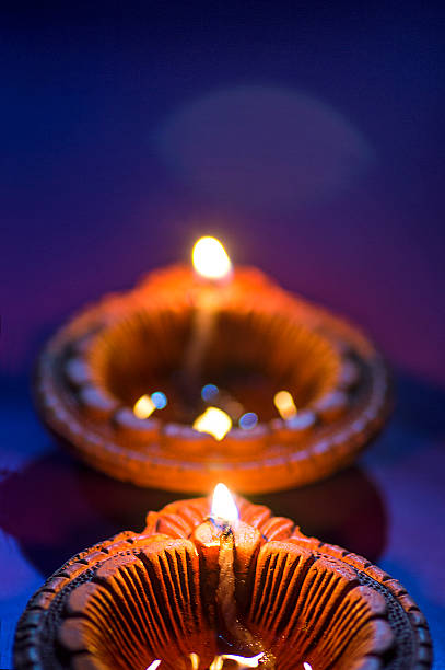 clay diya lamps lit during diwali celebration. greetings card design - vertical bright brightly lit vibrant color imagens e fotografias de stock