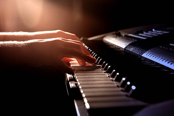istock Close up of child's hands playing piano 607743568