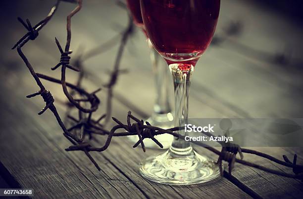 Rusty Barbed Wire And Glasses With Red Wine Stock Photo - Download Image Now - Abstract, Abuse, Addiction