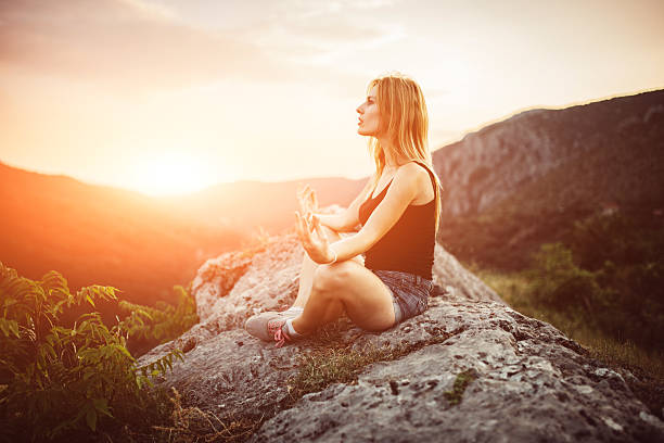 istock Girl sitting on mountain 607744320