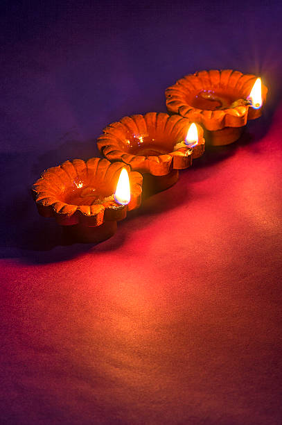 clay diya lamps lit during diwali celebration. greetings card design - vertical bright brightly lit vibrant color imagens e fotografias de stock