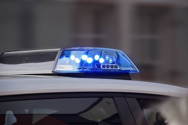 istock police car with blue lights switched on 607746476