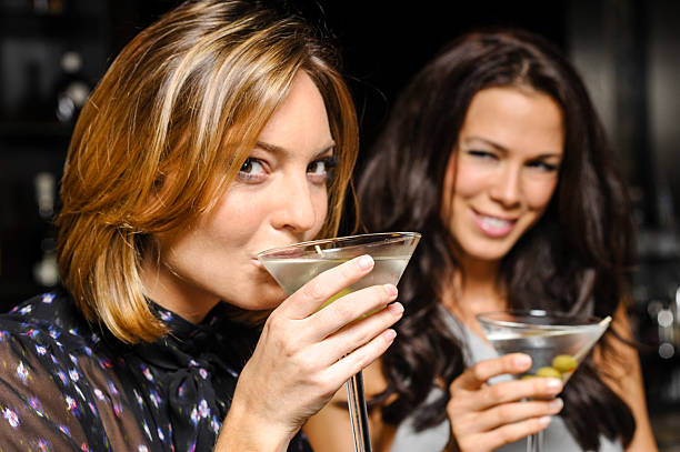 istock Two women drinking martinis in bar 607746834