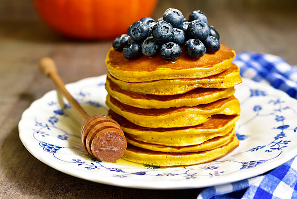 istock Pumpkin pancakes with fresh blueberry and honey. 607747172