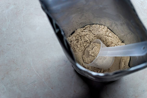 istock Measuring Whey in a Bag of Whey Protein Powder 607747936