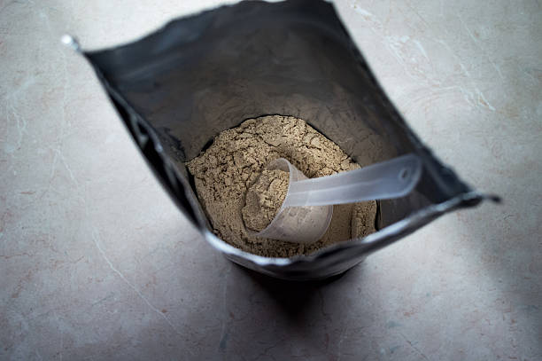 istock Measuring Whey in a Bag of Whey Protein Powder Overhead 607748046