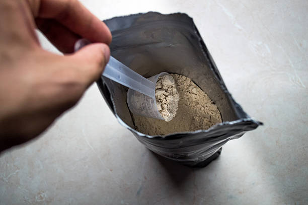 istock Hand Measuring Whey in a Bag of Whey Protein Powder 607748148
