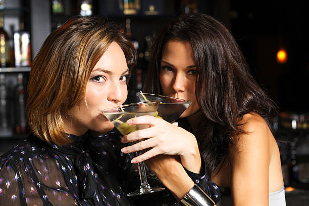 istock Two Young Women Drinking Martinis in Bar 607748474