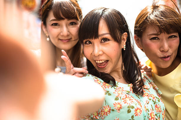 istock japanese friends take a selfie on the park 607748552