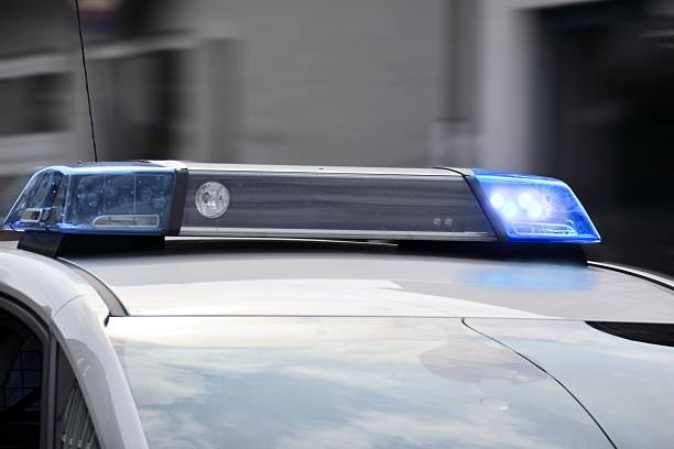 istock police car with blue lights switched on 607748832