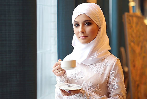 istock Muslim Girl Drinking Tea In Cafe 607749218