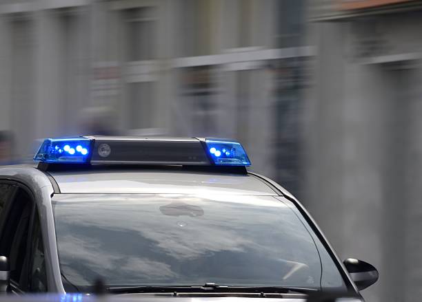 istock police car with blue lights switched on 607749264