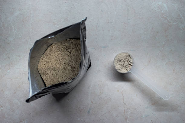 istock Bag of Whey Protein Powder and Scoop Overhead View 607749284