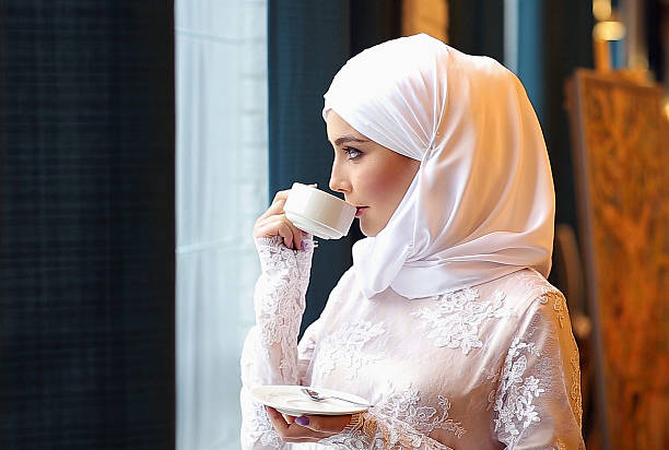 istock Muslim Girl Drinking Tea In Cafe 607749292