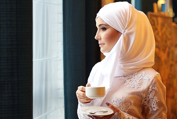 istock Muslim Girl Drinking Tea In Cafe 607749326