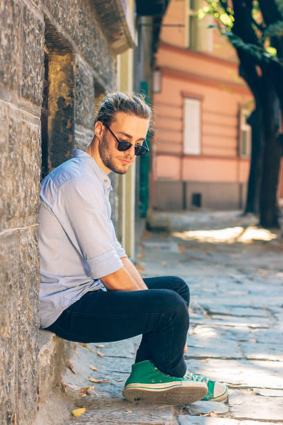 istock young attractive guy on the street 607751814