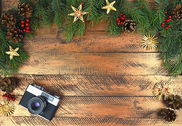 istock Old camera and branches of a Christmas tree. and tinsel .. 607754288