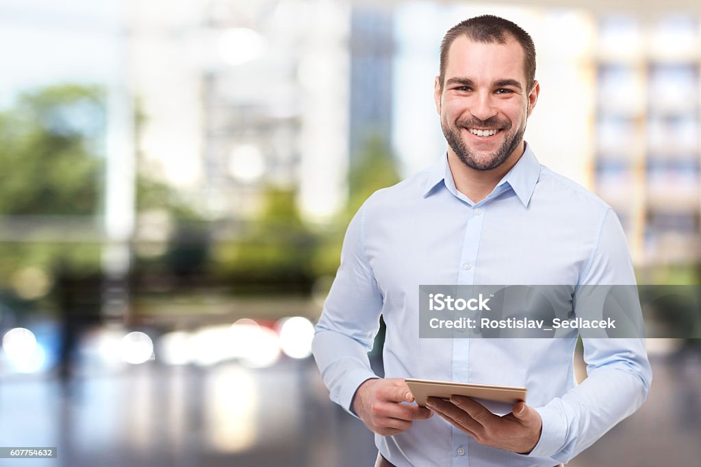 Man in office with tablet computer Portrait of professional business man in office with tablet computer Men Stock Photo