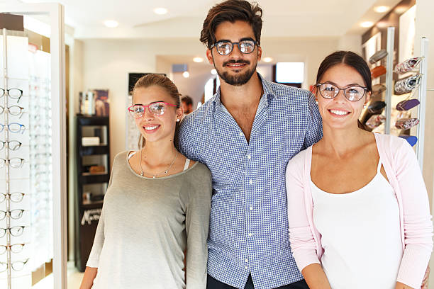 Optician store. Group of young people wearing eyeglasses in optician store. group of people wearing eyeglasses stock pictures, royalty-free photos & images