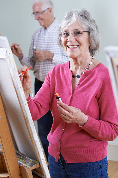 istock Seniors Attending Painting Class Together 607756018