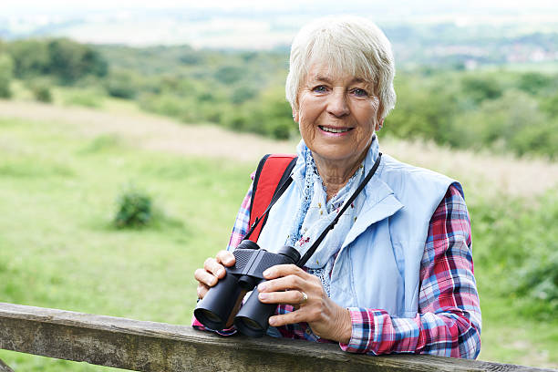 istock Senior Woman On Walk With Binoculars 607756386