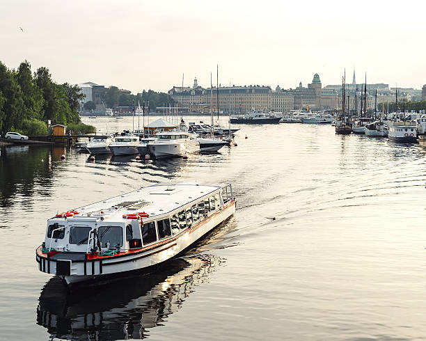 istock White civil passenger boat at the channel in summer 607756560