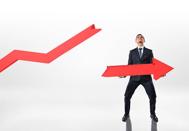 istock Businessman holding big broken arrow with both hands isolated on 607757074