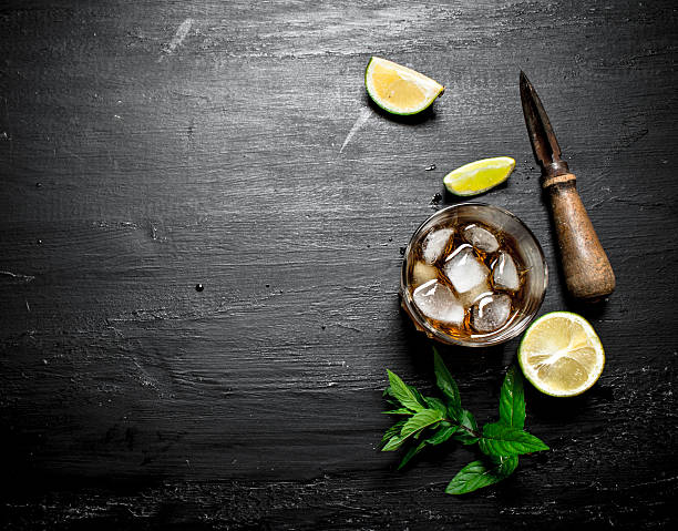 istock glass of rum with lime and mint. 607758924