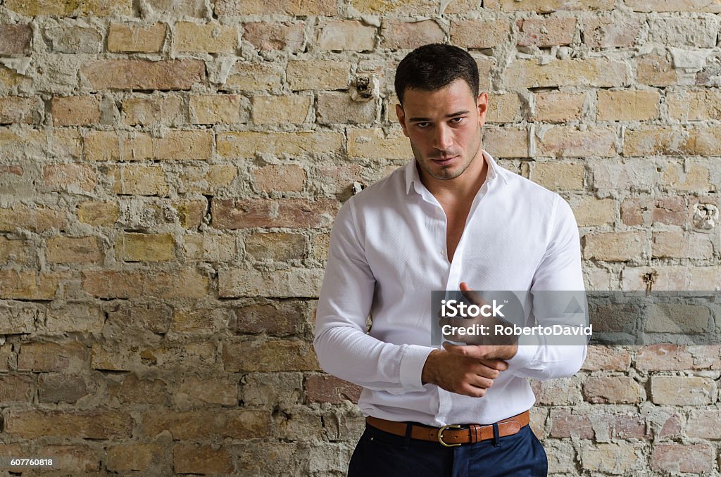 Portrait businessman posing in front of the old wall Men Stock Photo