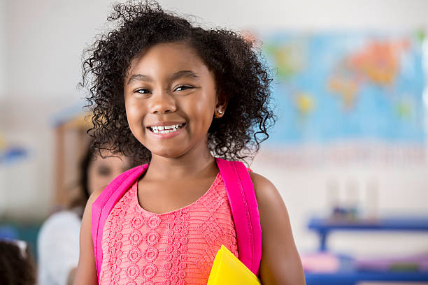 istock Adorable little girl in her classroom 607761000