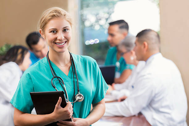 istock Confident young intern at medical meeting 607761100