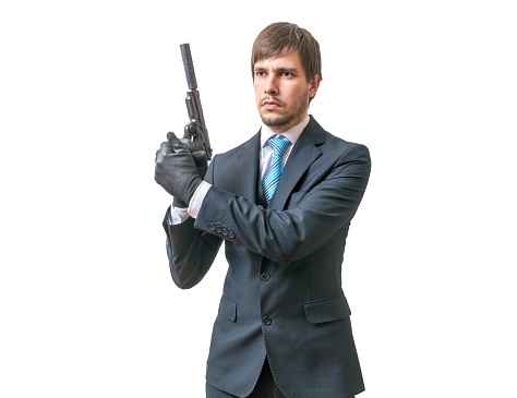 Bodyguard or agent with pistol in hands. Isolated on white background.