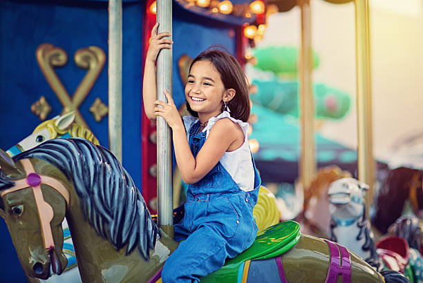 Little girl on carousel Happy girl is ride a hourse on carousel carousel photos stock pictures, royalty-free photos & images