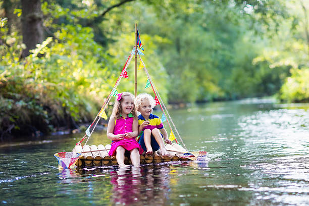 istock Kids on wooden raft catching fish 607768294