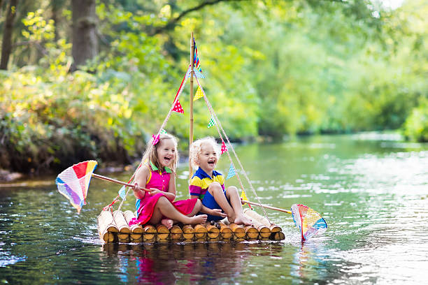 istock Happy kids on wooden raft 607769632