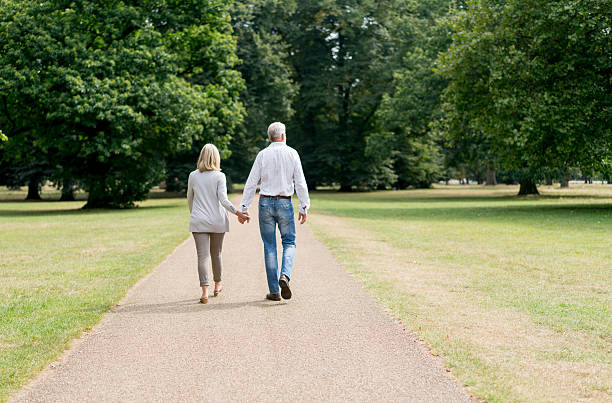 istock Loving couple walking at the park 607770246