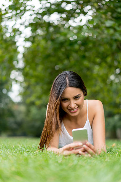 istock Happy woman text messaging outdoors 607770258