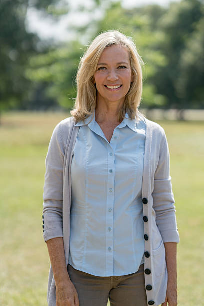 istock Happy woman relaxing at the park 607770336