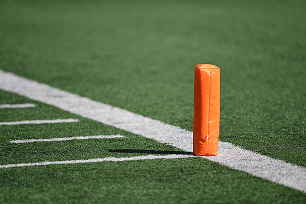 Football field pylon A pylon on a football field. yard measurement stock pictures, royalty-free photos & images