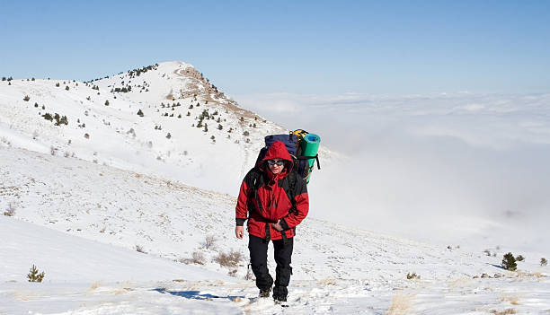 istock Hiker are in winter mountains 607771940