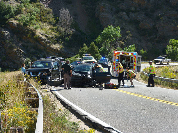 Head-on car suv crash emergency Bear Creek Canyon Morrison Colorado Morrison, Colorado, USA - September 19, 2016: Two black vehicles stand crumpled side by side on a clear day in Bear Creek Canyon as ambulance EMT staff work on a small car driver after a head-on crash. morrison stock pictures, royalty-free photos & images