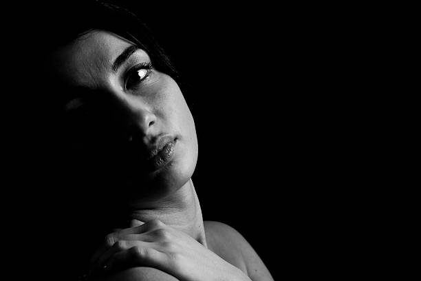 istock Woman BW Low Key Studio Portrait 607773302