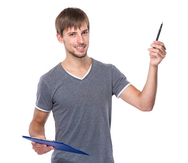 istock Man holding a clipboard and pen 607773972