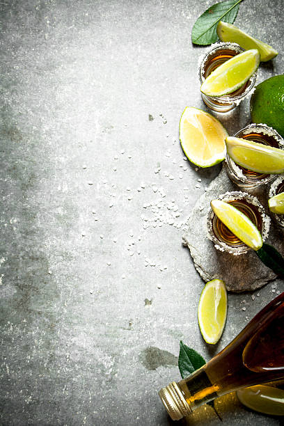 istock Tequila with salt and lime slices. 607774640